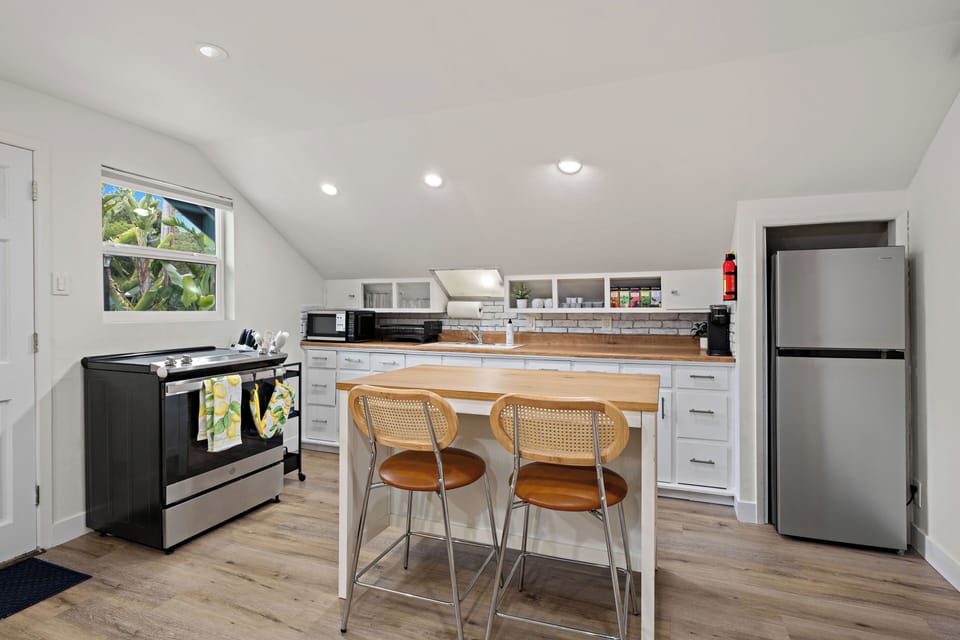 Cook, sip coffee, or gather around the island in the fully stocked kitchen.