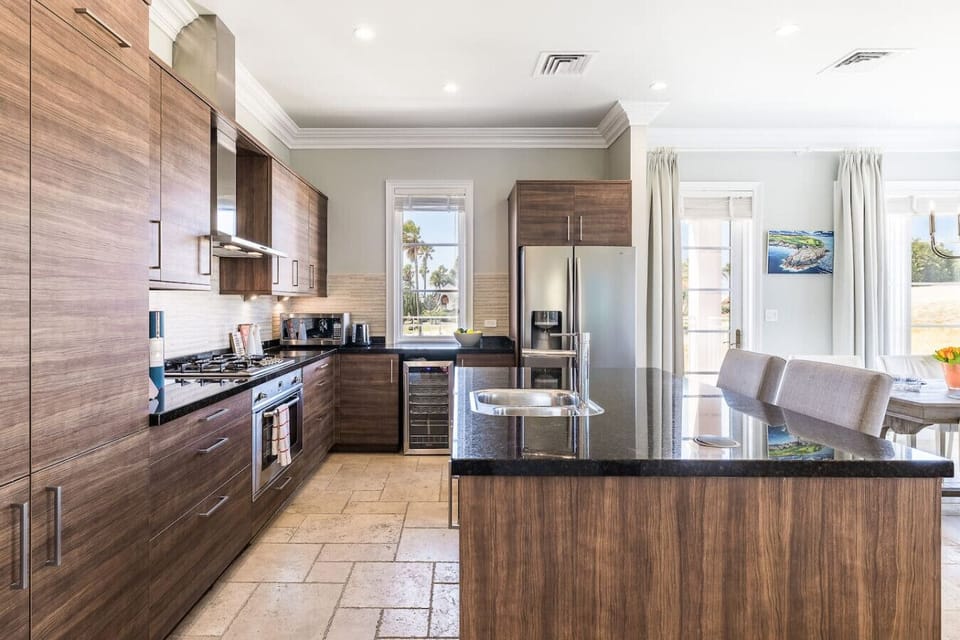 Cook and entertain in style with this spacious kitchen featuring a central island, perfect for meal prep and gathering with loved ones.