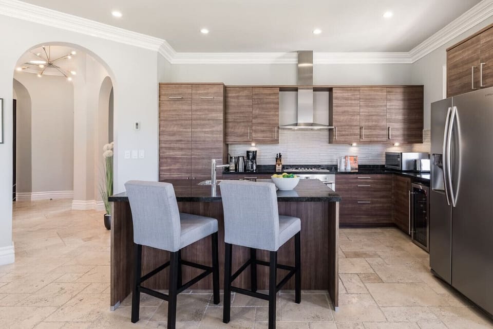 Cook and entertain in style with this spacious kitchen featuring a central island, perfect for meal prep and gathering with loved ones.