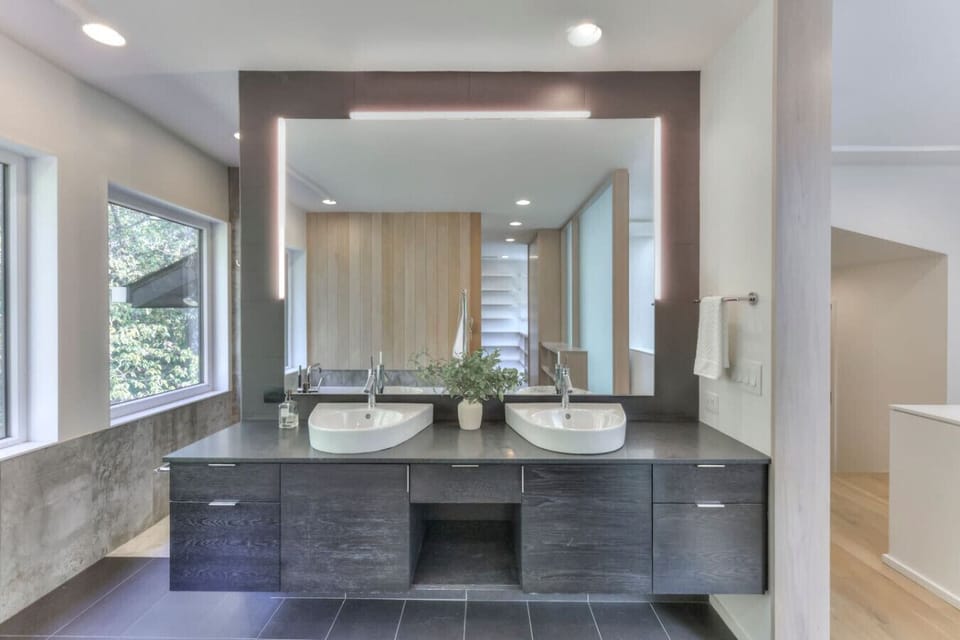 Primary bedroom's luxury bathroom suite with a double vanity, a tub, and a huge standing shower.