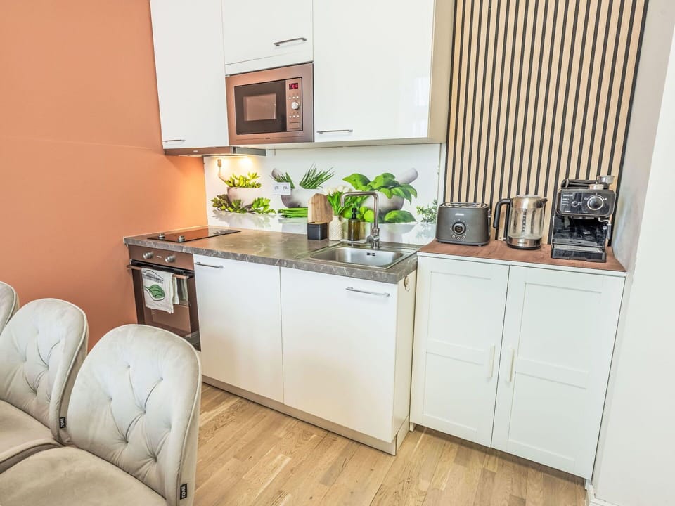 Furniture, Interior Design, Flooring, Wood, Kitchen Appliance, Major Appliance, Floor, Room, Cabinetry, Kitchen