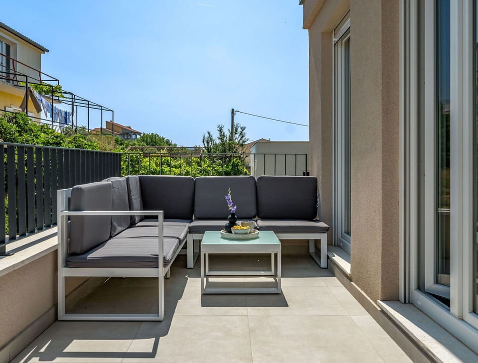 Furniture, Outdoor Furniture, Flooring, Floor, Chair, Outdoor Table, Patio, Balcony, Shade