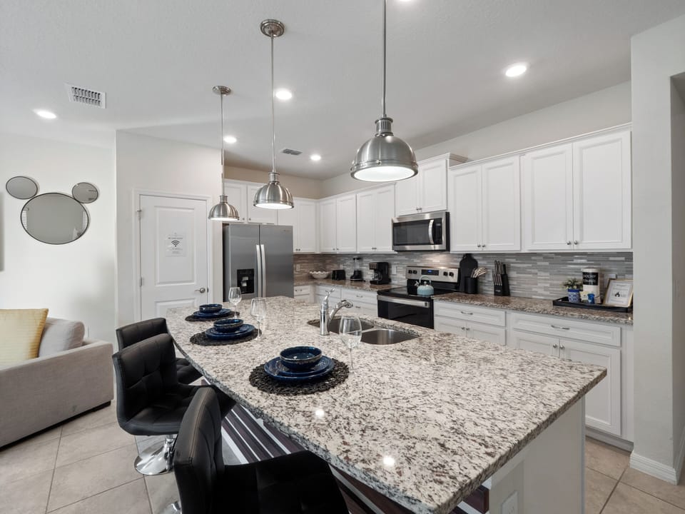 Fully Equipped Kitchen with Comfortable Bar Seating, Stainless steel appliances and everything you need to cook at home.