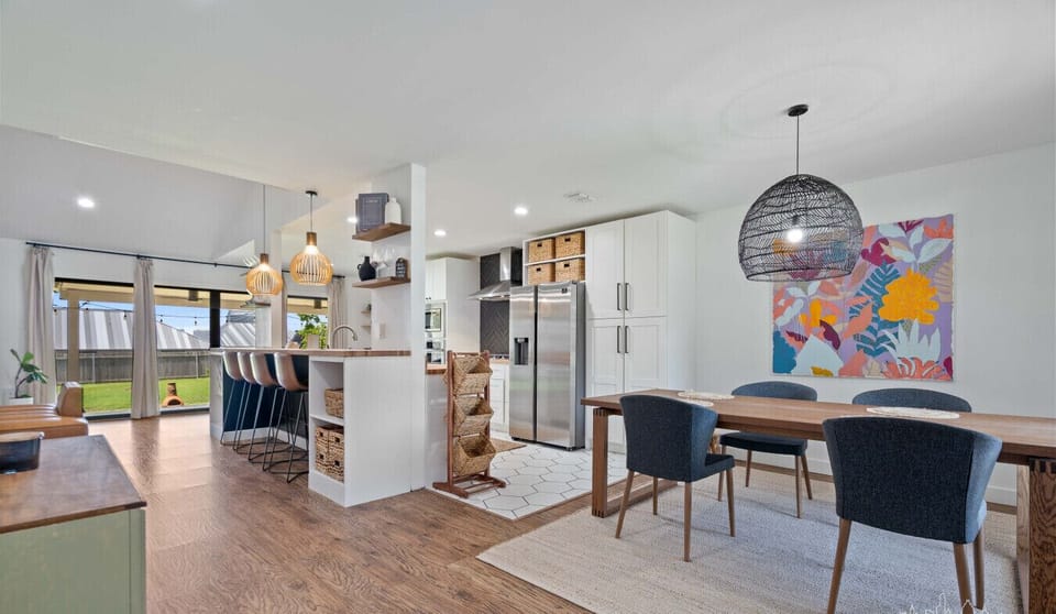 Open layout, easy flow. Seamless movement from kitchen to table to couch without missing a moment.