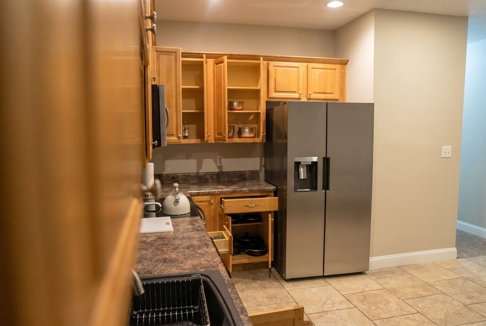 Functional kitchen with full-size fridge, ample cabinets, and prep space