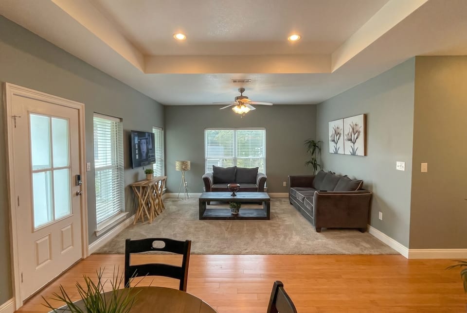 Bright, spacious living room with high ceilings and cozy seating