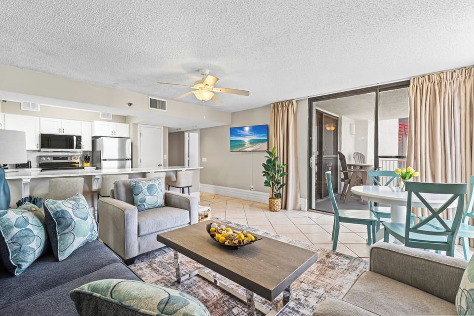 Relax in your bright, open-plan suite with modern kitchen, comfortable seating, and private balcony access.