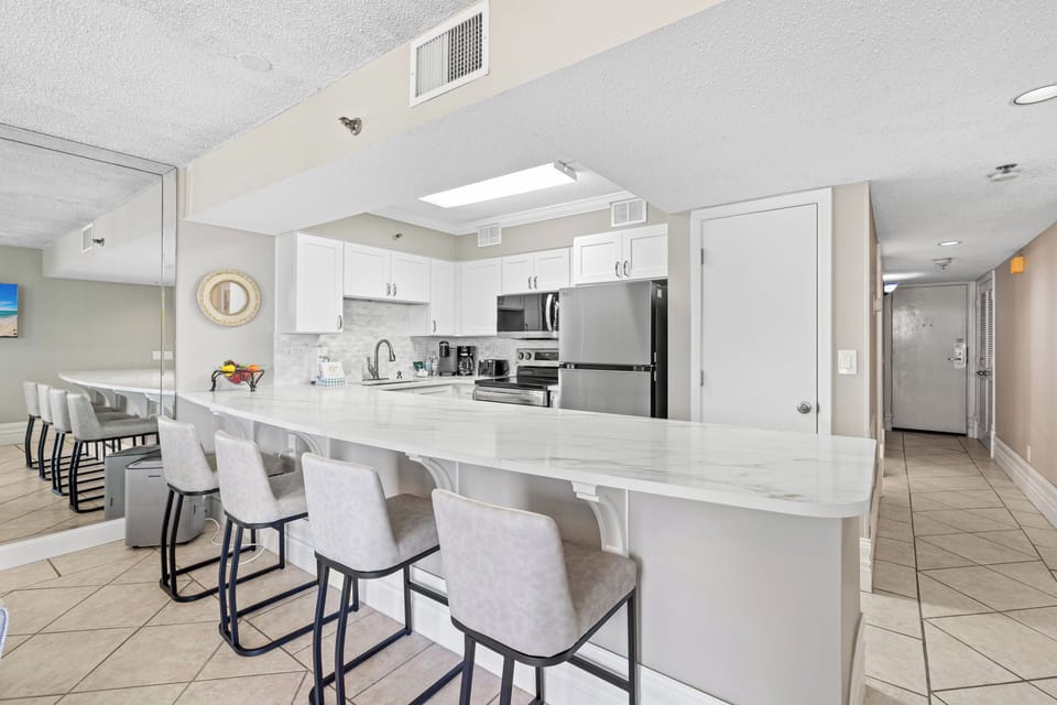 Gather around this spacious kitchen island where marble countertops and modern appliances make cooking effortless and entertaining memorable.