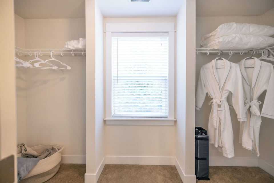 The primary closet features plush robes and slippers, providing extra comfort. 