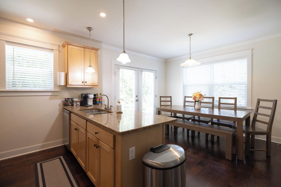Kitchen storage include cookware baking sheets, blender and toaster. 