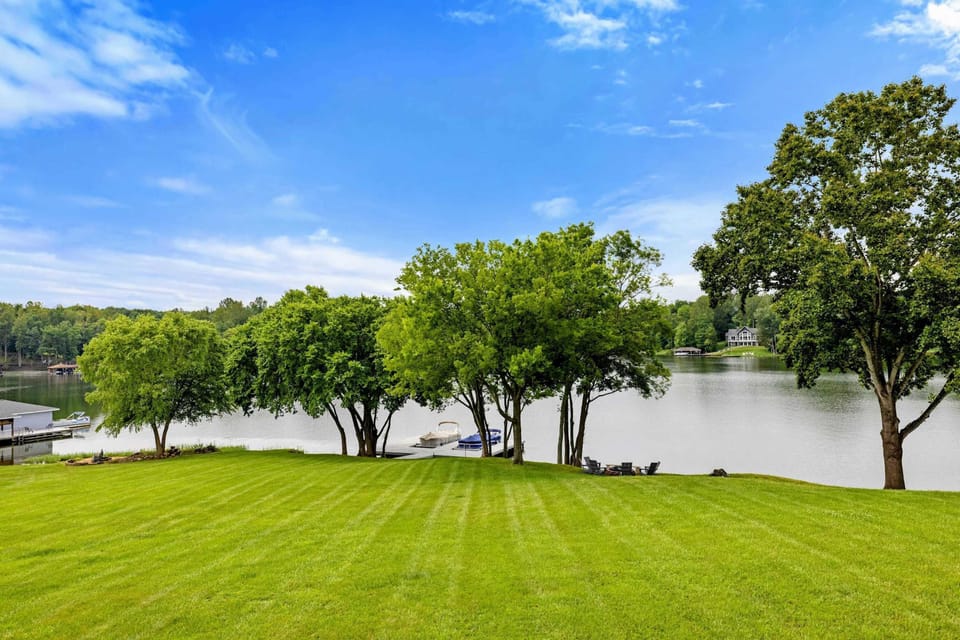 Lake Panorama - The sweeping view from the deck across the lawn, through the shade trees, and out to the open lake.
