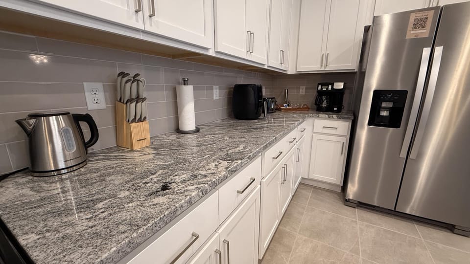 Modern kitchen with stainless steel appliances and ample counter space.