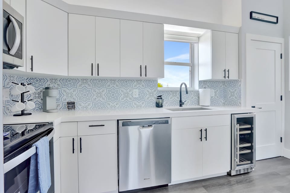 Kitchen |  Modern appliances, beverage fridge, fully stocked with cooking essentials.