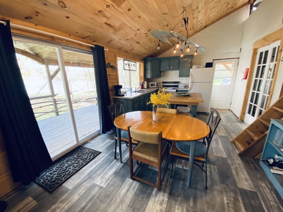 Experience the inviting charm of an open and cozy floor plan that effortlessly connects the kitchen, dining area, and living space. Slide open the glass doors to embrace the expansive covered porch, where you can savor breathtaking views of the lake.
