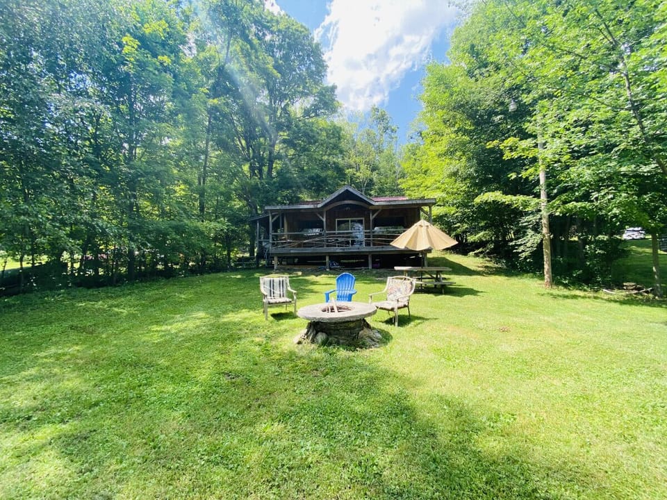 Enjoy the serenity of nature sitting by the fire pit or large front porch.