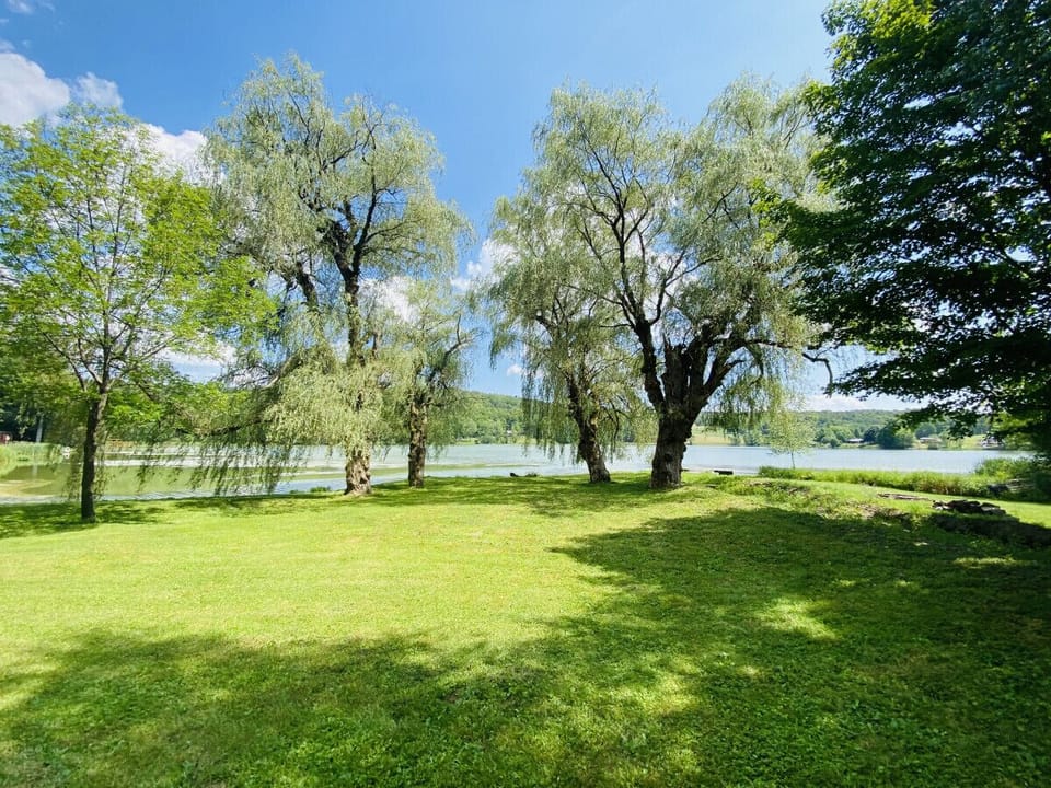 Savor stunning lake views from the porch, luxurious hot tub, cozy firepit, or manicured lawn. Enjoy the ideal backdrop for relaxation and unforgettable moments.