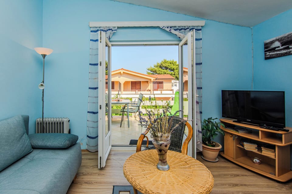 Standard Apartment, Balcony, Partial Sea View | Living area | 100-cm LCD TV with cable channels
