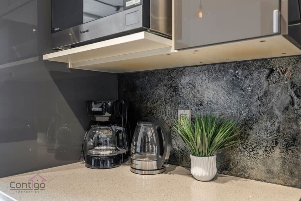 Coffee and tea station with kettle, coffee maker, and everything you need for your morning brew.