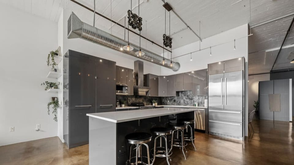 Large modern kitchen with upscale stainless steel appliances  great for dining in.