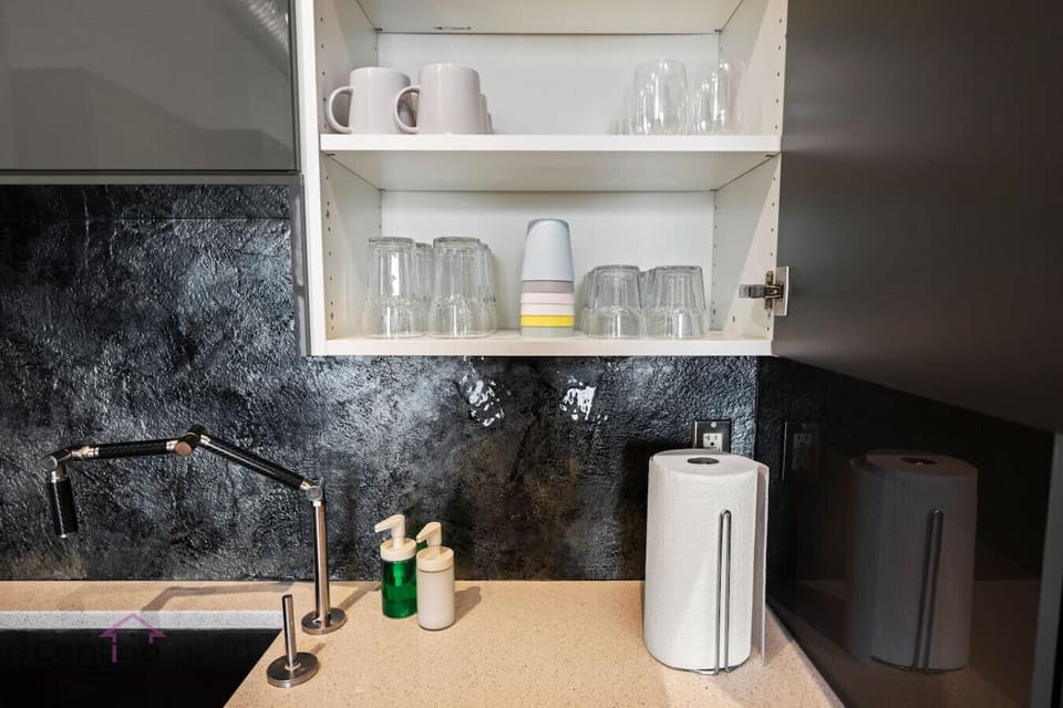Well-stocked kitchen with glasses, mugs, and essentials for your stay.