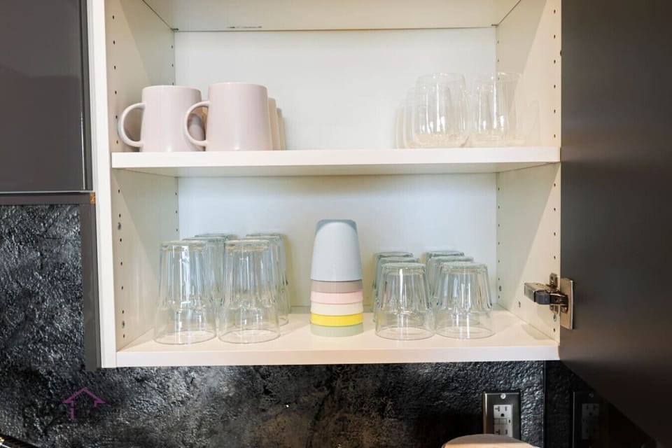 Plenty of glassware, mugs, and colorful cups.  Perfect for families or groups.