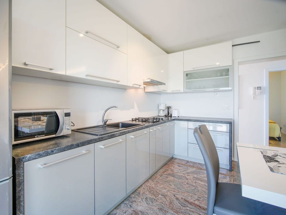 Flooring, Interior Design, Kitchen, Major Appliance, Countertop, Floor, Kitchen Appliance, Room, Cabinetry, Ceiling