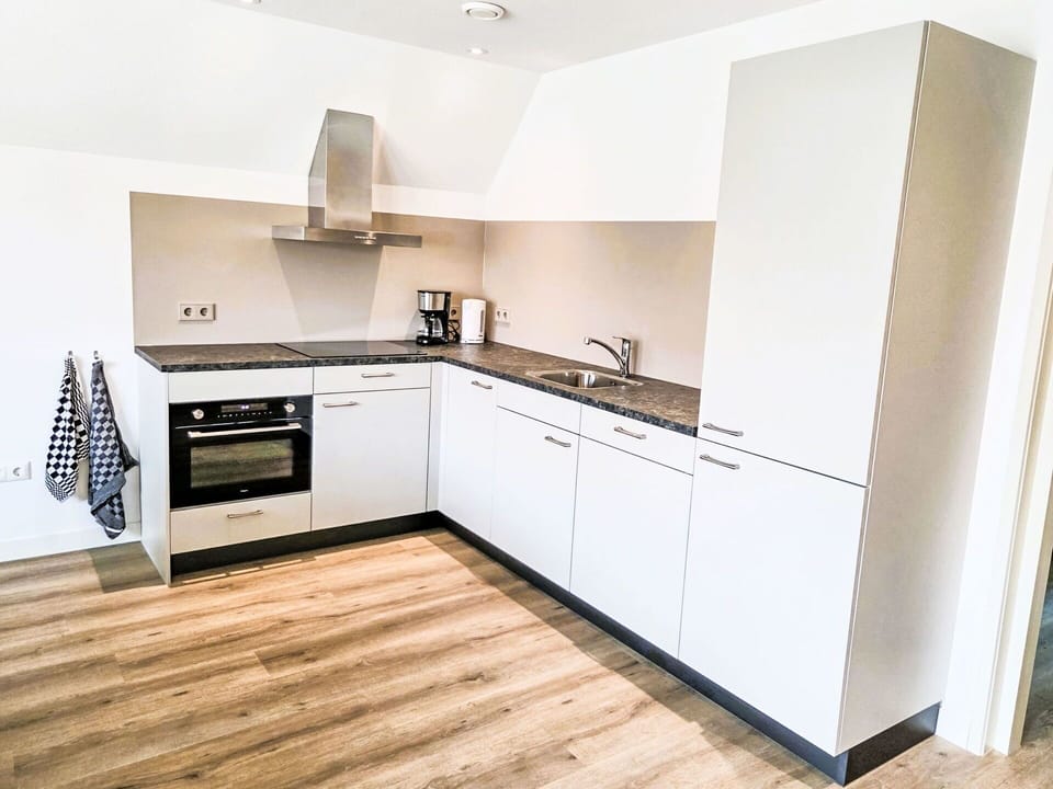 Flooring, Interior Design, Floor, Wood, Kitchen, Wood Flooring, Cabinetry, Kitchen Appliance, Ceiling, Room