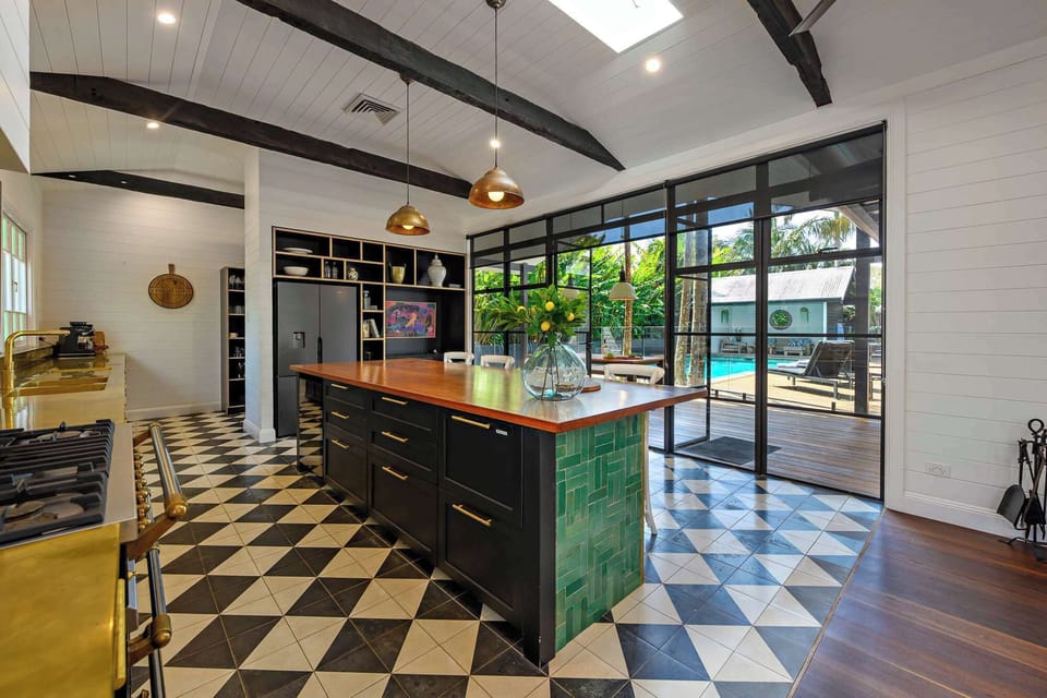 Light-filled kitchen with seamless flow to the pool deck — perfect for entertaining, family meals and relaxed indoor-outdoor living.