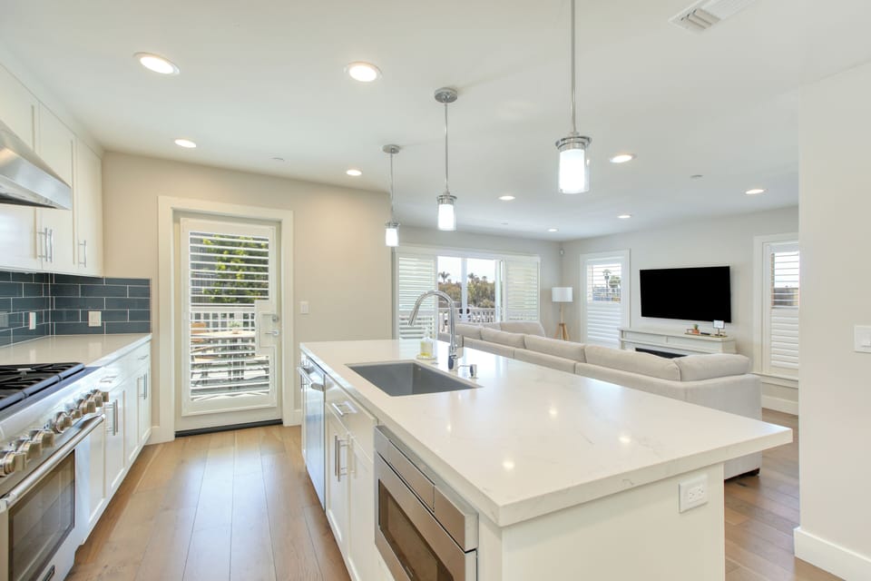 An airy open-concept living space bathed in natural light invites you to unwind and connect.