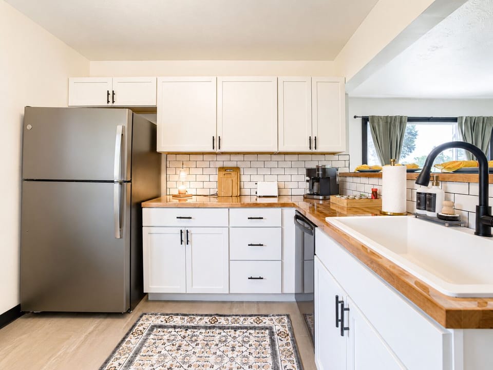 Bright modern kitchen with butcher block counters and farmhouse sink