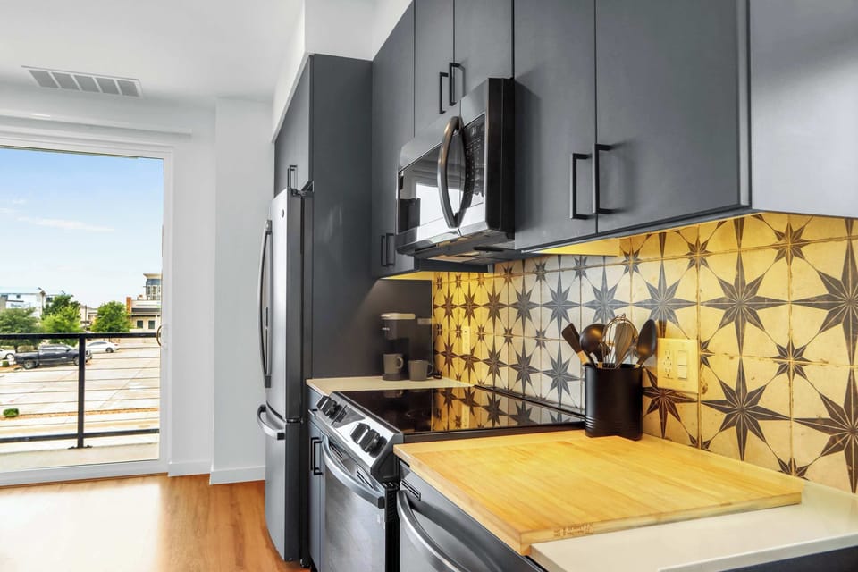 Condo, 1 Queen Bed with Sofa bed, Balcony (Creekside Modern) | Private kitchen | Fridge, microwave, oven, stovetop