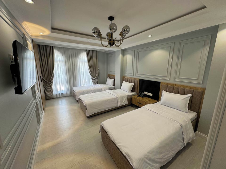 Triple Room, City View | In-room safe, laptop workspace, blackout drapes, soundproofing