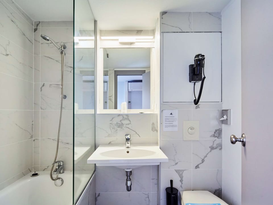 Bathtub, eco-friendly toiletries, hair dryer, towels