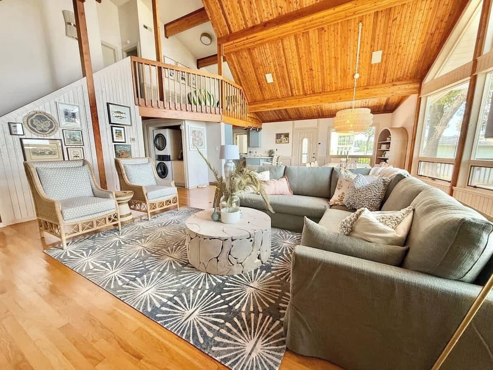 Views of open loft area and additional seating in living area