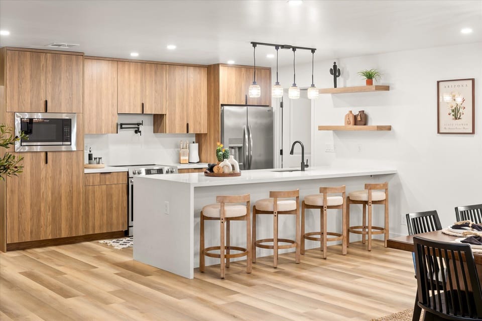 Sleek and spacious, kitchen features modern appliances and a large island.