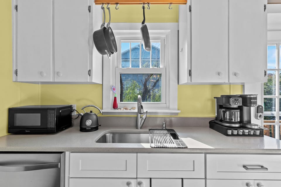 Updated kitchen fully stocked with cookware, coffee essentials, filtered water, and everything needed for cooking during your beach vacation