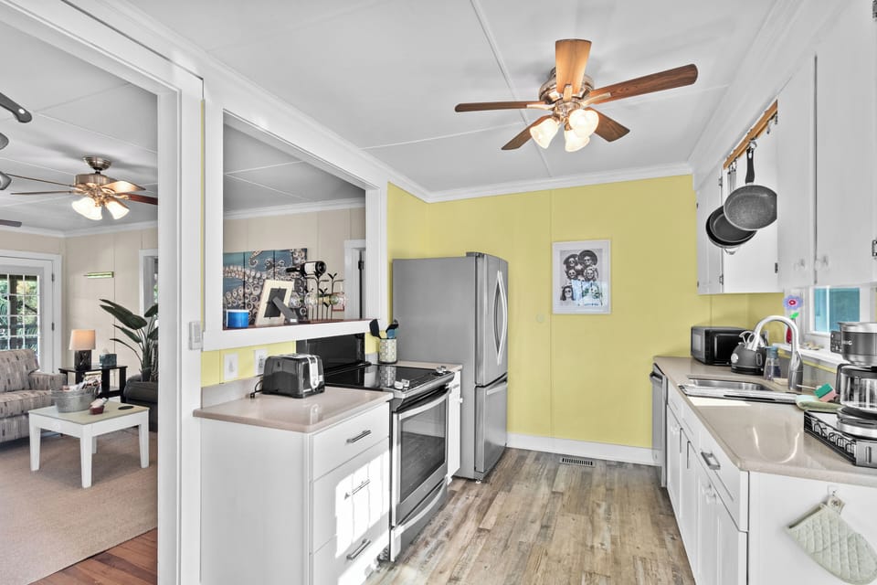Updated kitchen fully stocked with cookware, coffee essentials, filtered water, and everything needed for cooking during your beach vacation