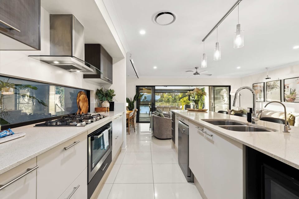 Spacious kitchen with large bench space, 5 stools, and a walk-in pantry. Equipped with a full fridge, large stove/oven, air fryer, coffee setup, salad platters, baking provisions and placemats. Perfect for cooking, entertaining & enjoying your stay!