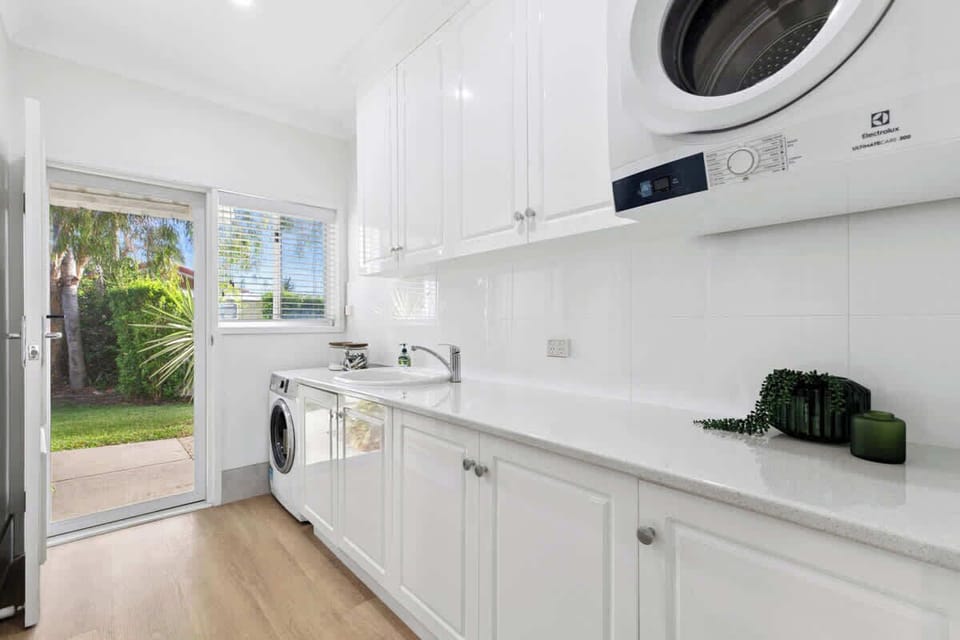 Bright, well-appointed laundry with washer and dryer, generous bench space and storage. Convenient access to the outdoors makes longer stays easy, practical and comfortable for families and groups.