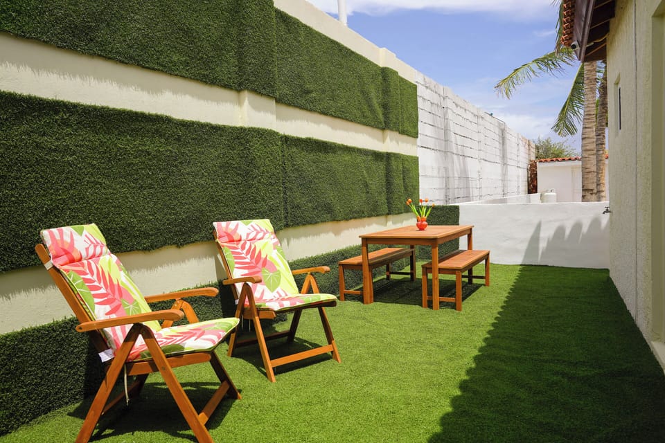 Patio with lounge chairs and picnic table.