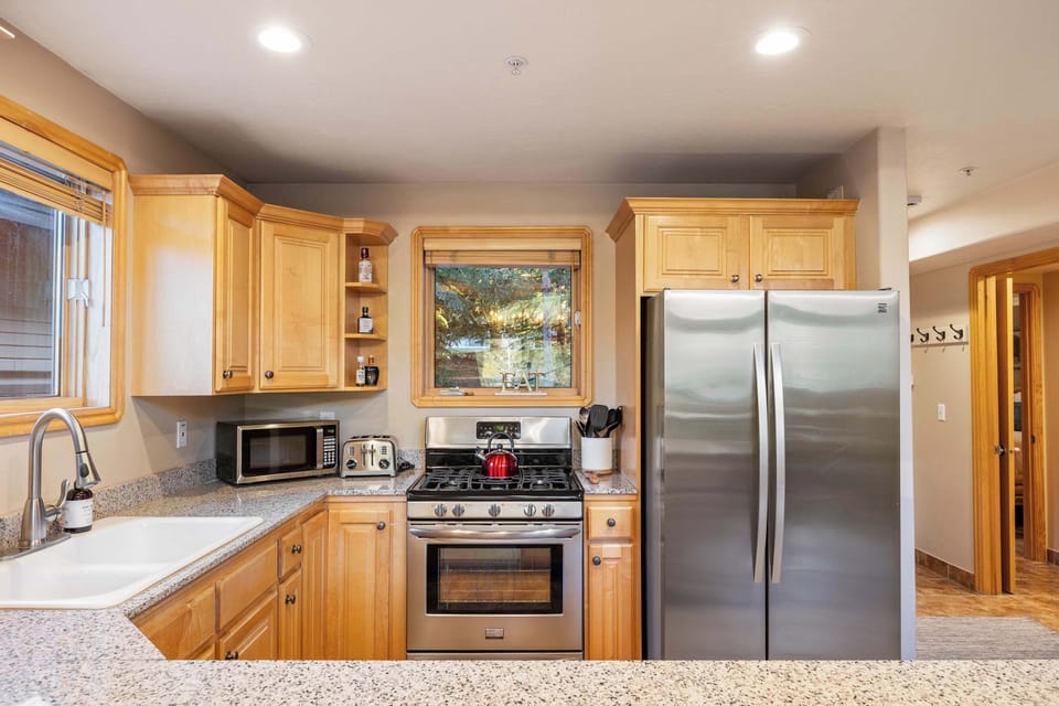 Sleek stainless steel appliances and quartz countertops ready for culinary adventures.