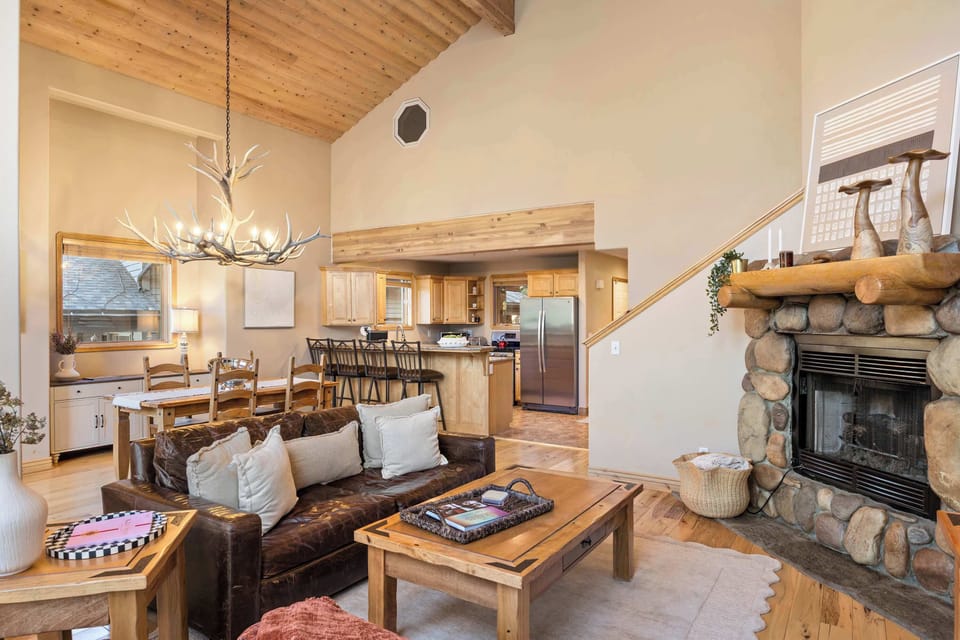 Living Room with Stone Fireplace – Cozy seating arranged around the stone fireplace and large windows.