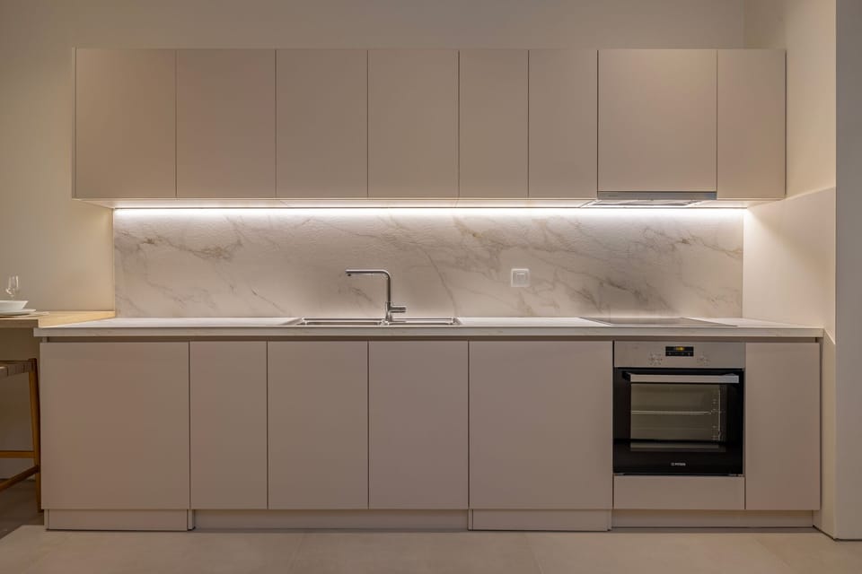 Fully equipped kitchen featuring a Nespresso machine, oven, refrigerator