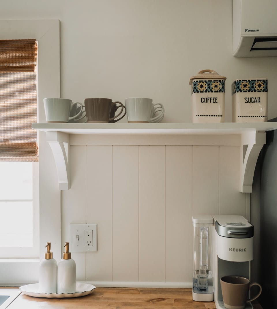 The kitchen includes a dedicated coffee station with everything you need to start your mornings right, conveniently set up for a smooth, easy routine.