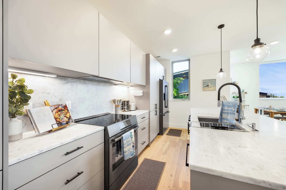 Cook in style with stainless steel appliances, sleek white cabinetry, and a big countertops.