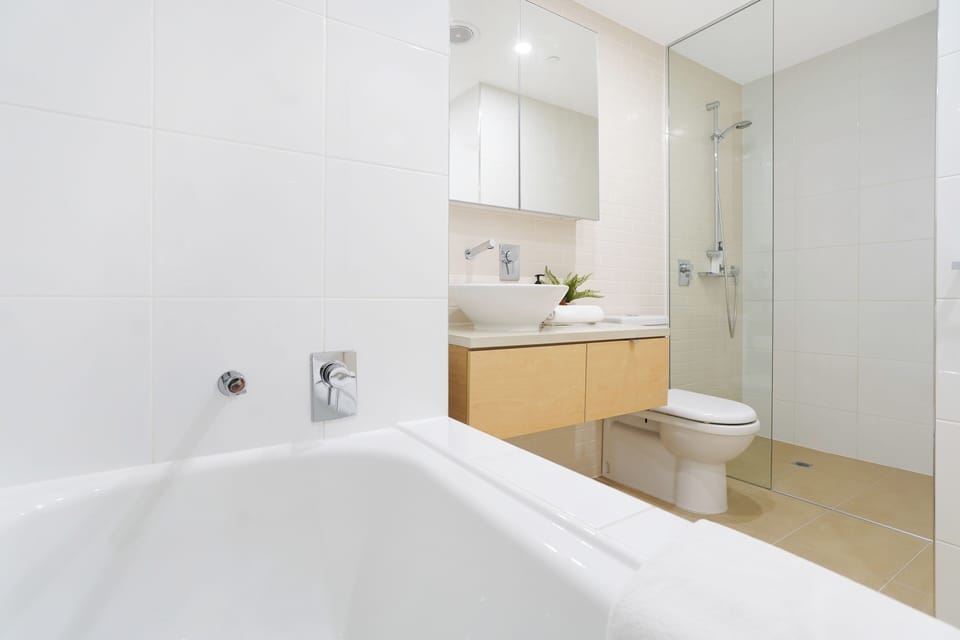 Main family bathroom with large bath, shower and toilet.