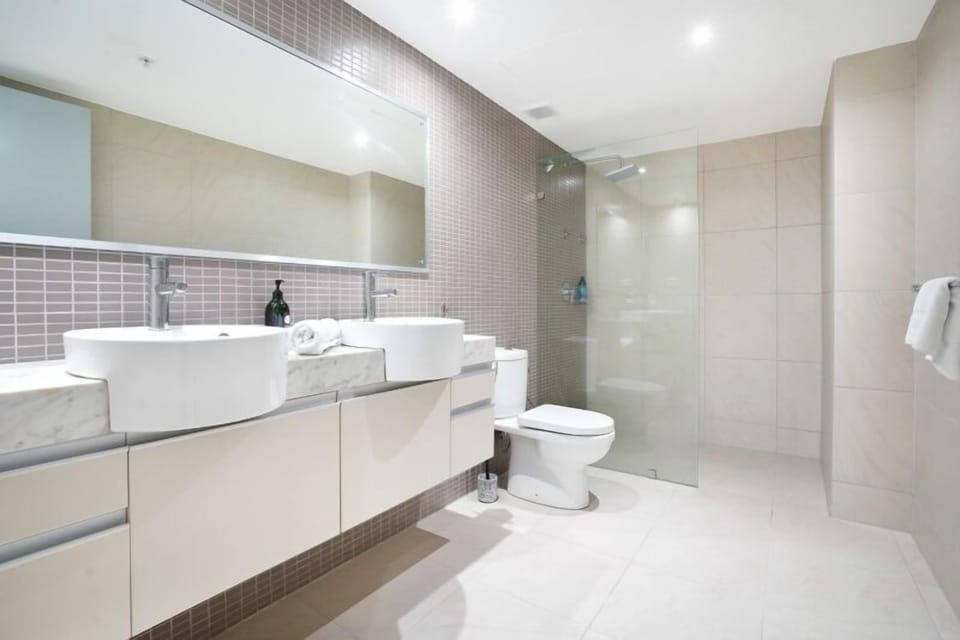 Ensuite bathroom with double basin, walk in shower and toilet.