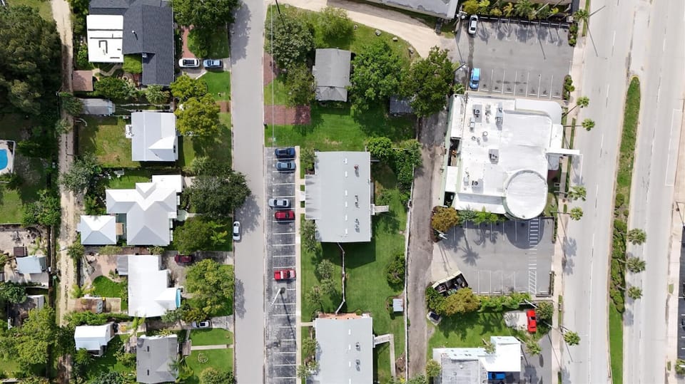 - Top-down aerial shot showing layout of building and parking lot  
- Convenient parking spaces available directly next to the units  
- Easy access to local shops and dining just minutes from the property