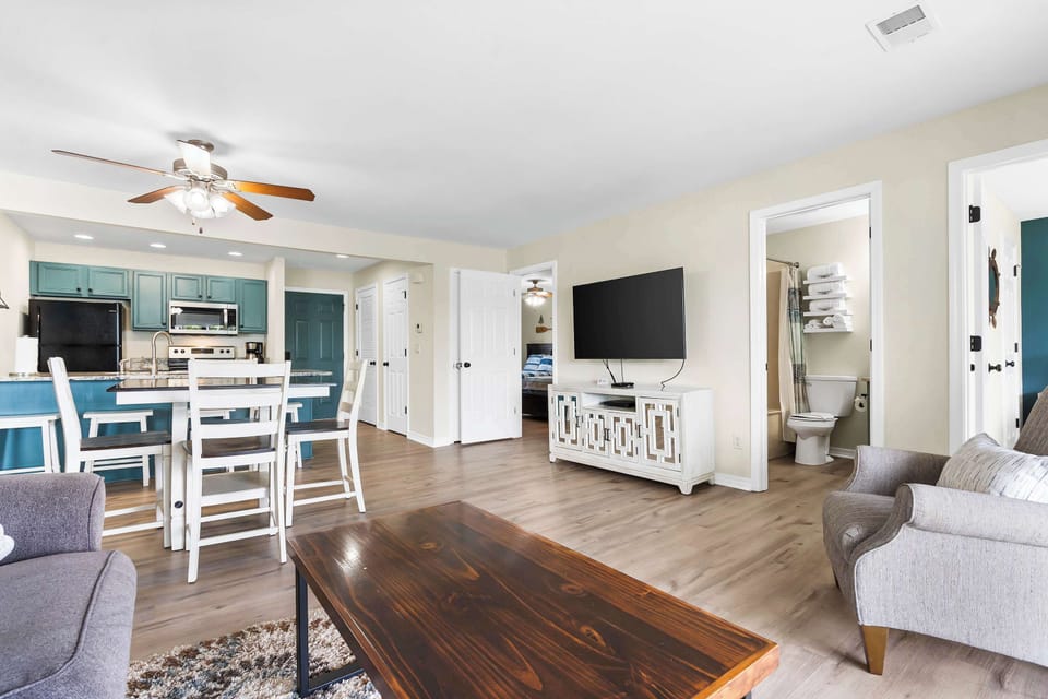 Bright living area with sofa sleeper, and TV