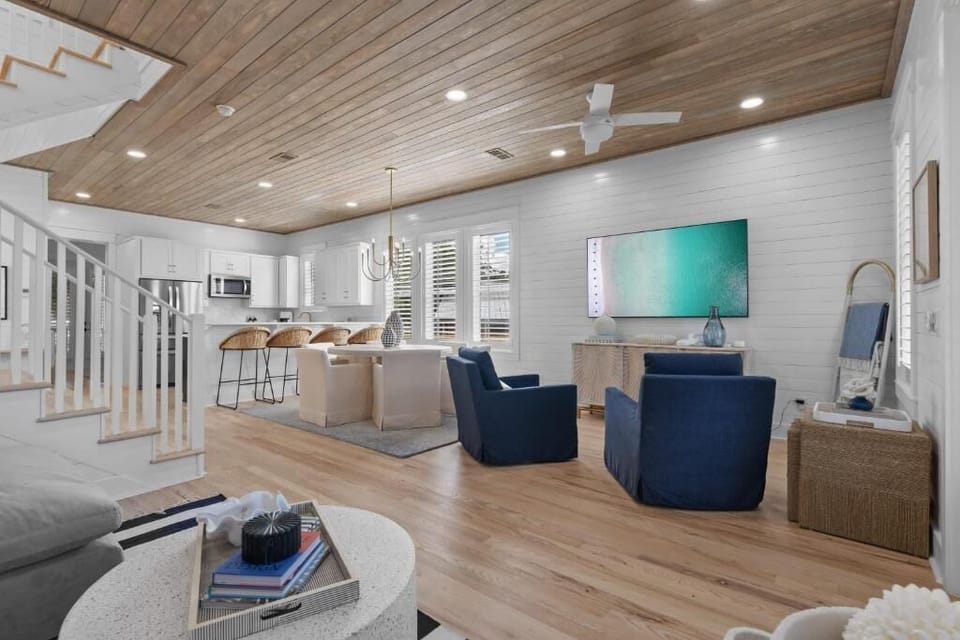 Bright open living area w/ vaulted wood ceilings & cozy seating for gathering